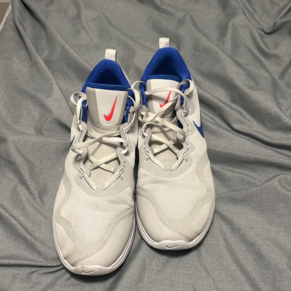 Nike White Sneakers with Blue/ Red highlights.